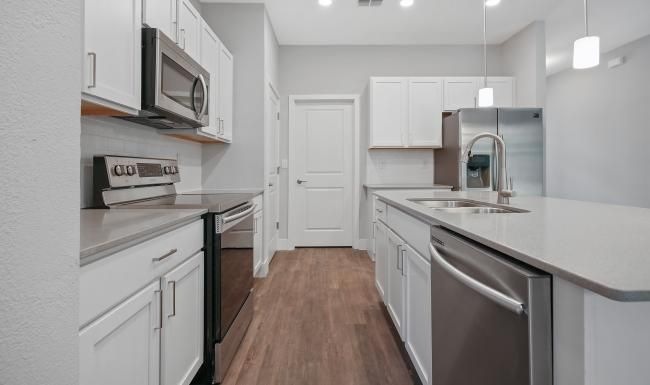 a kitchen with white cabinets