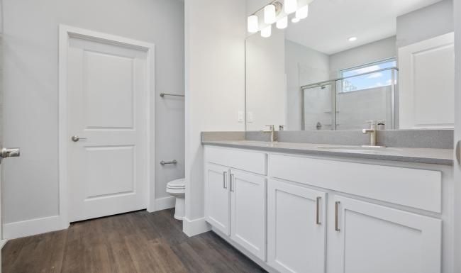 a bathroom with white cabinets